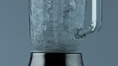 Cocktail-blender-grinding-ice-closeup.-Barkeeper-equipment-crushing-frozen-cubes