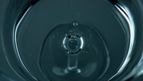 Liquid-droplet-falling-water-top-view.-Closeup-refreshing-drink-waving-rippling
