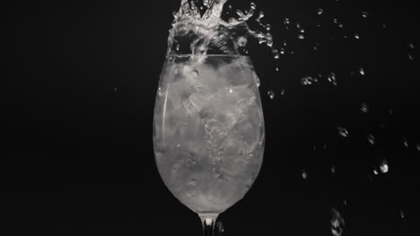 Mineral-water-pouring-ice-glass-closeup.-Preparing-cocktails-and-beverages