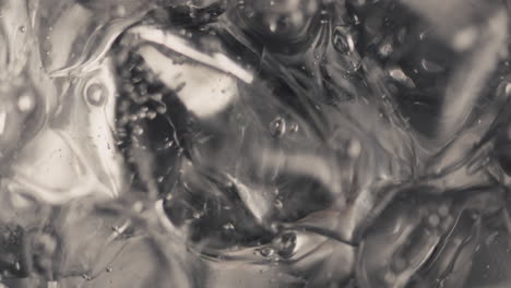 Ice-cubes-sparkling-water-spinning-closeup-in-slow-motion.-Beverage-concept
