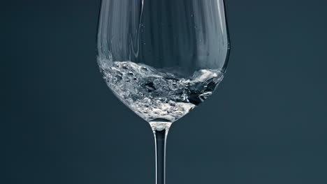 Clear-water-filling-cup-closeup.-Pure-refreshing-beverage-pour-into-transparent