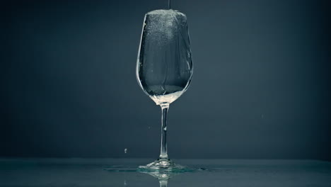 Pure-water-overflowing-glass-closeup.-Cool-refreshing-liquid-spilling-wine-cup