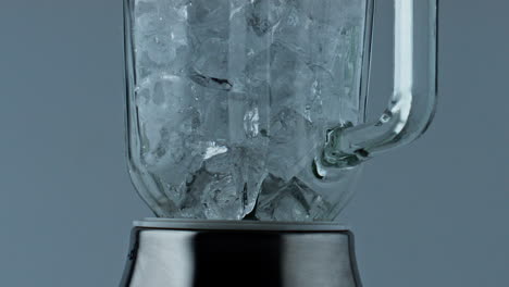 Ice-cubes-container-falling-closeup.-Cocktail-blender-filling-with-iced-chunks