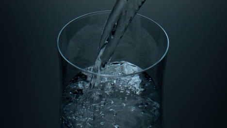 Pure-water-pouring-cup-closeup.-Refreshing-liquid-bubbling-filling-glass-jug