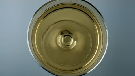 Winery-droplet-falling-glass-top-view.-Grape-juice-liquid-rippling-waving-in-cup