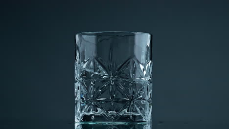 Glass-water-waves-moving-in-beautiful-cup-closeup.-Transparent-liquid-splashing