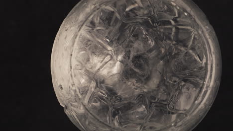 Forceps-throw-lemon-water-glass-closeup.-Making-cocktail-process-concept