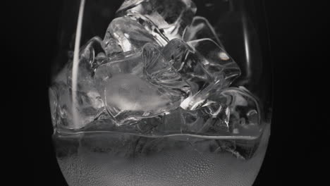 Frozen-blocks-melting-wineglass-macro-closeup.-Thirst-quencher-concept