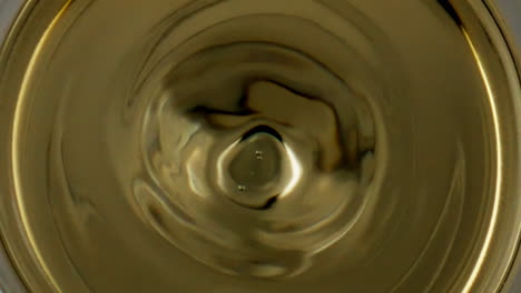 Wine-drop-splashing-goblet-closeup.-Smooth-liquid-surface-rippling-waving-in