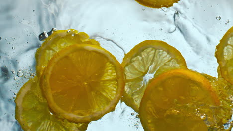 Sliced-sour-lemon-falling-water-making-splashes-in-super-slow-motion-close-up.
