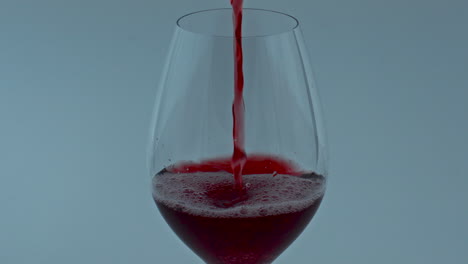 Clear-gourmet-liquor-flowing-down-wineglass-closeup.-Red-wine-streaming-in-glass