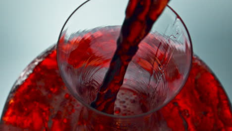 Intoxicant-red-beverage-filling-decanter-slow-motion.-Wine-forms-waves-glassware