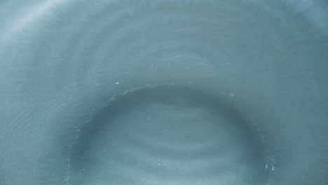 Aqua-blob-splashed-transparent-liquid-closeup.-Falling-drop-inside-water-surface
