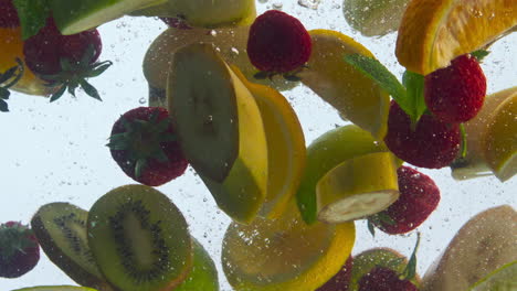 Mix-fruits-dropped-water-in-super-slow-motion-closeup.-Various-juice-ingredients