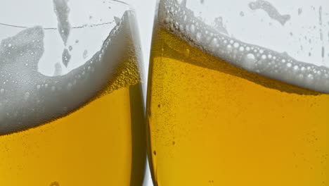 Lager-beer-glasses-cheers-gesture-closeup.-Full-ale-vessels-toasting-together