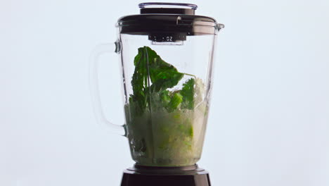 Blender-preparing-vegetable-smoothie-cocktail-in-super-slow-motion-close-up.