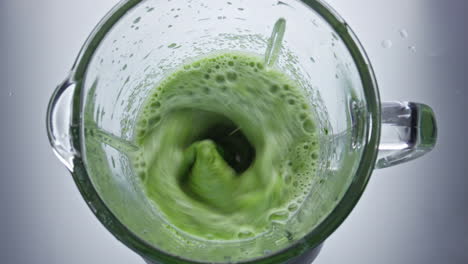 Closeup-green-vegetables-mix-in-blender-top-view.-Healthy-vegan-smoothie.
