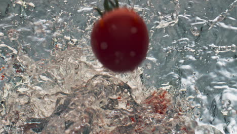 Closeup-tomatoes-splashing-liquid-closeup.-Delicious-organic-food-commercial.