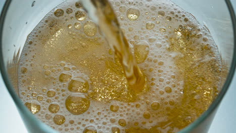 Closeup-craft-beer-filling-glass-slow-motion.-Alcoholic-liquid-bubbling-goblet