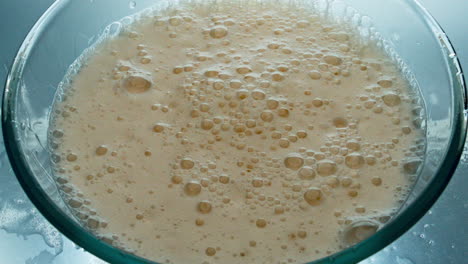Foamy-lager-beer-surface-top-view.-Alcoholic-drink-bubbles-bursting-slowly