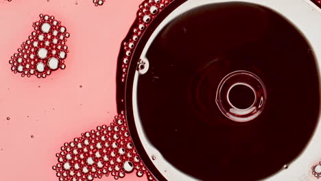 Sparkling-liquid-inside-wineglass-closeup.-Rose-wine-bubbling-goblet-bottom-view