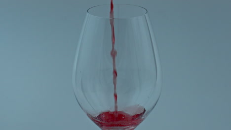 Streaming-spirituous-luxury-liquid-indoors-closeup.-Red-drink-filling-wine-glass