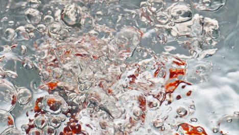 Tasty-tomatoes-falling-water-closeup.-Delicious-cherry-veggies-splashing-bubbles