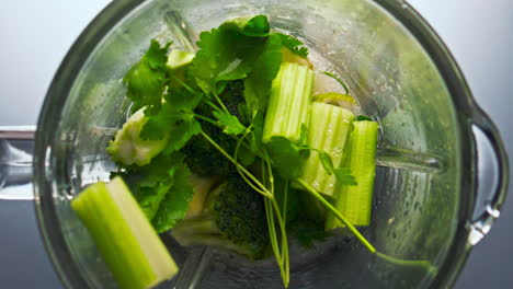 Pieces-vegetables-inside-blender-preparing-in-super-slow-motion-closeup.