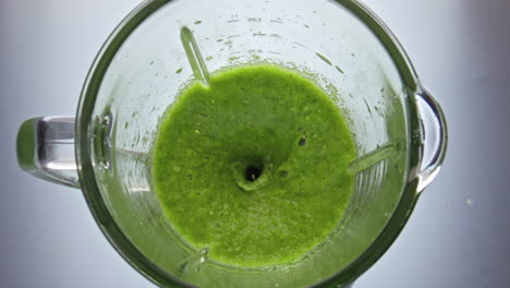 Green-vegan-cocktail-mixing-in-blender-close-up-super-slow-motion.-Healthy-food.