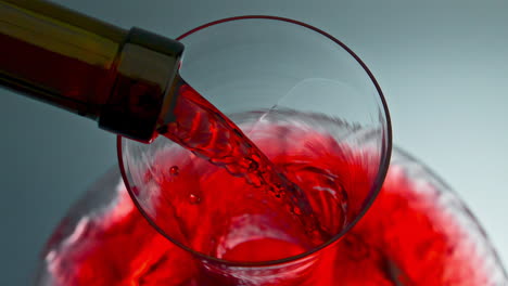 Red-wine-stream-pouring-glassware-from-bottle-neck.-Rose-drink-filling-decanter