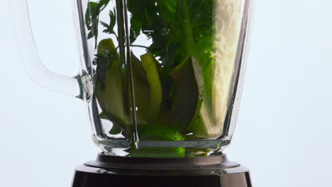 Closeup-falling-organic-vegetables-in-blender-super-slow-motion.-Vegan-nutrition