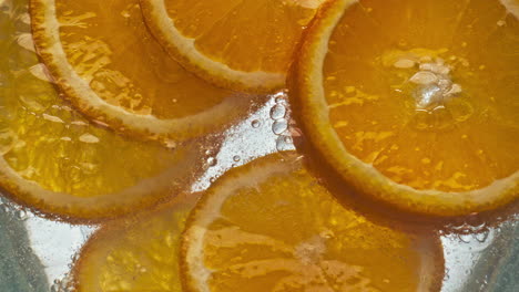 Closeup-oranges-fizzy-water-in-light-background.-Refreshing-citrus-beverage
