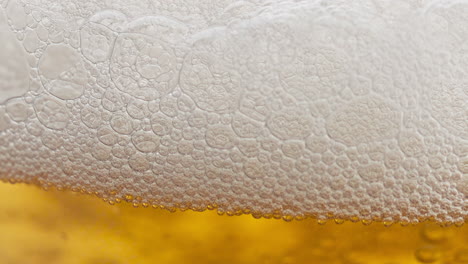 Closeup-beer-foam-sizzling-bubbling-inside-goblet.-Barley-alcohol-drink-vessel