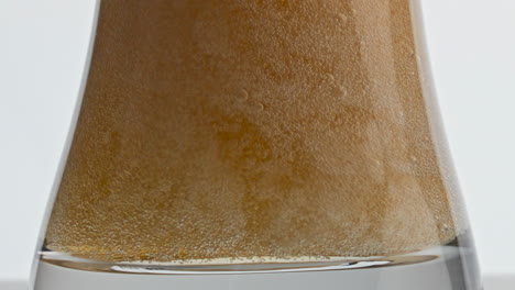 Pasteurized-lager-beer-bubbling-vessel-closeup.-Barley-beverage-inside-goblet