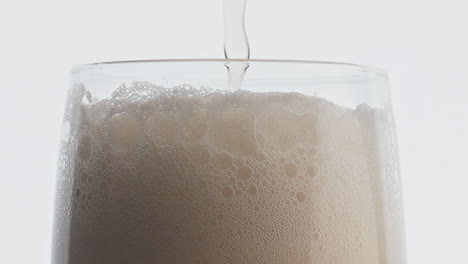 Foamy-beer-stream-pouring-glass-closeup.-Unfiltered-drink-filling-glassware