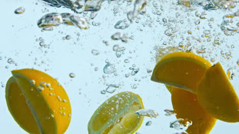Orange-wedges-dropped-water-closeup.-Pieces-citrus-floating-under-clear-liquid.