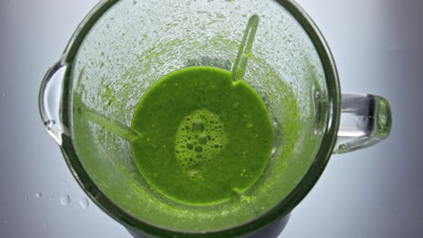 Closeup-green-smoothie-preparing-in-blender-super-slow-motion.-Healthy-cocktail.