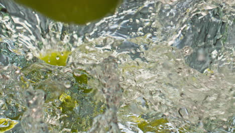 Closeup-green-apples-splashing-bubbling-water.-Beautiful-organic-fruits-falling