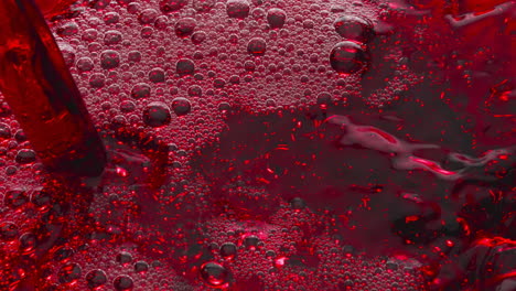 Bubbled-red-wine-pouring-glass-slow-motion.-Alcoholic-liquor-filling-wineglass