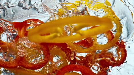 Fresh-pepper-fall-liquid-in-super-slow-motion.-Red-yellow-tasty-paprika-closeup.