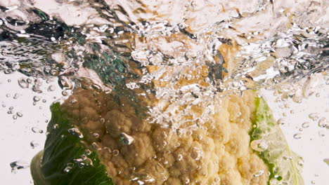 Fresh-cauliflower-falling-water-closeup.-Organic-garden-vegetable-splashing