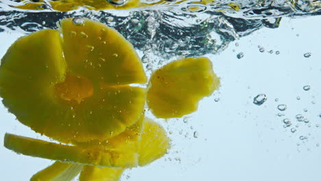 Pieces-pineapple-dropped-water-in-super-slow-motion-close-up.-Ananas-floating.