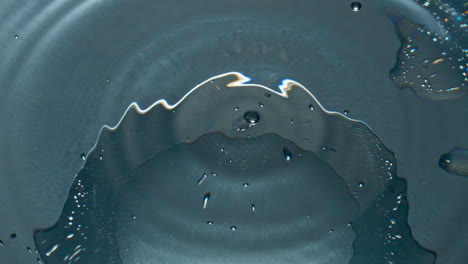 Blob-splashing-inside-glassware-closeup.-Drop-falling-cocktail-in-slow-motion