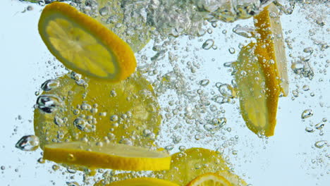 Sliced-orange-fall-water-in-super-slow-motion-close-up.-Citrus-pieces-floating.