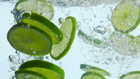 Dropping-lime-slices-water-in-super-slow-motion-closeup.-Pieces-citrus-splashing