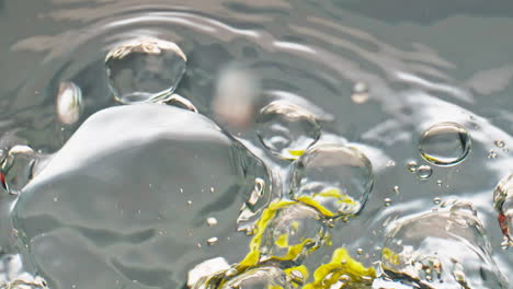 Closeup-lime-splashing-water-surface-top-view.-Tropical-organic-citrus-floating