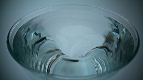 Closeup-ice-aqua-making-funnel-inside-glassware.-Container-with-rotating-liquid
