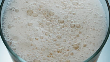 Sizzling-foam-ipa-beer-surface-closeup.-Hoppy-liquid-frothing-inside-goblet