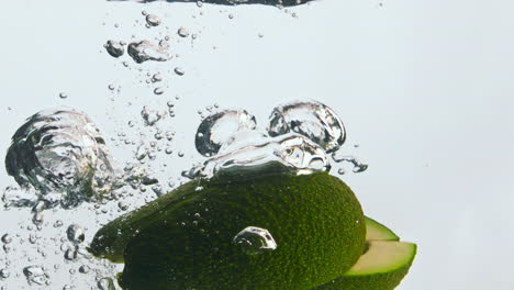Avocado-pieces-splashing-water-in-super-slow-motion-close-up.-Organic-tasty-food