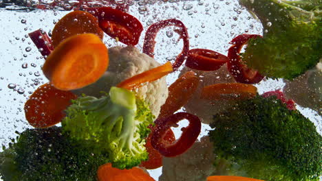 Mix-fresh-vegetable-falling-in-water-super-slow-motion-closeup.-Veggies-floating